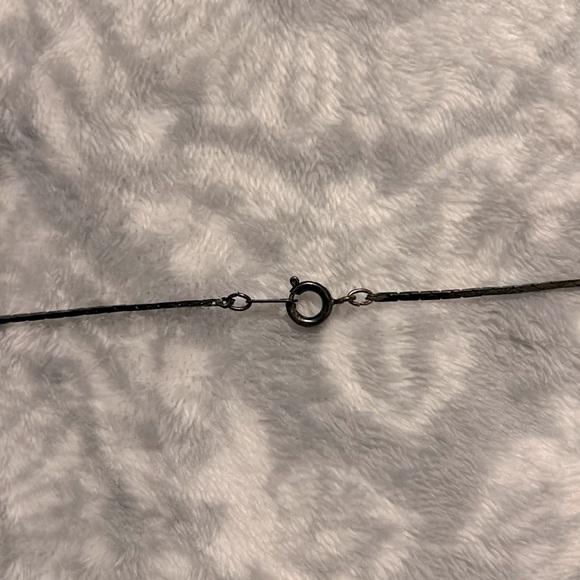 This is a bronze and black looking necklace. - Picture 4 of 5